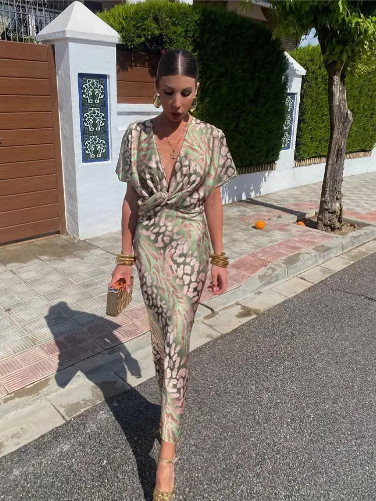 A woman wearing the Livia Women's Elegant Wrap Dress, featuring a luxurious wrap design with flowing short sleeves and a flattering silhouette. This luxe dress is perfect for upscale events or formal gatherings, showcasing sophisticated elegance and effortless style.