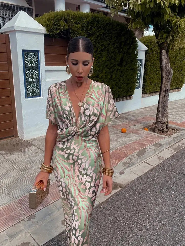 A woman wearing the Livia Women's Elegant Wrap Dress, featuring a luxurious wrap design with flowing short sleeves and a flattering silhouette. This luxe dress is perfect for upscale events or formal gatherings, showcasing sophisticated elegance and effortless style.
