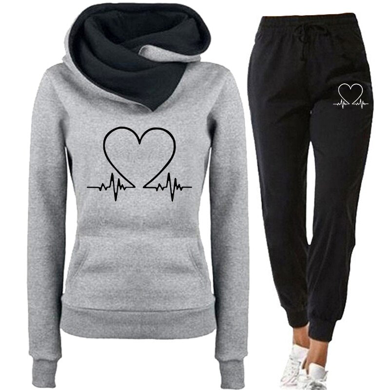 Women's comfortable tracksuit featuring a stylish design with a heart and heartbeat graphic, perfect for casual wear, workouts, or lounging.