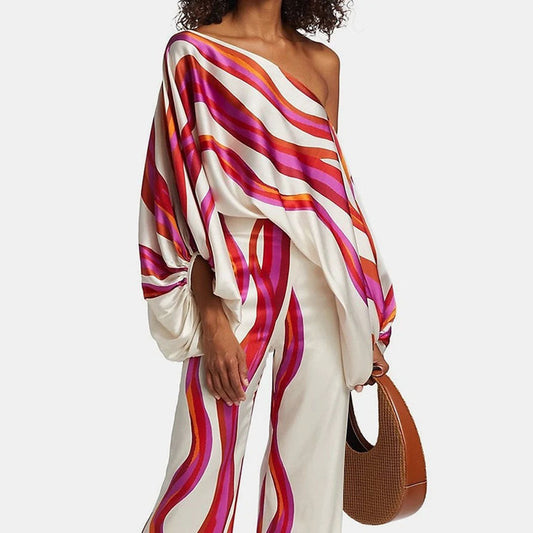 Women's summer jumpsuit with a flowing, one-shoulder design featuring vibrant patterns. Perfect for casual outings, beach days, or evening events, combining elegance and comfort for a chic summer look.