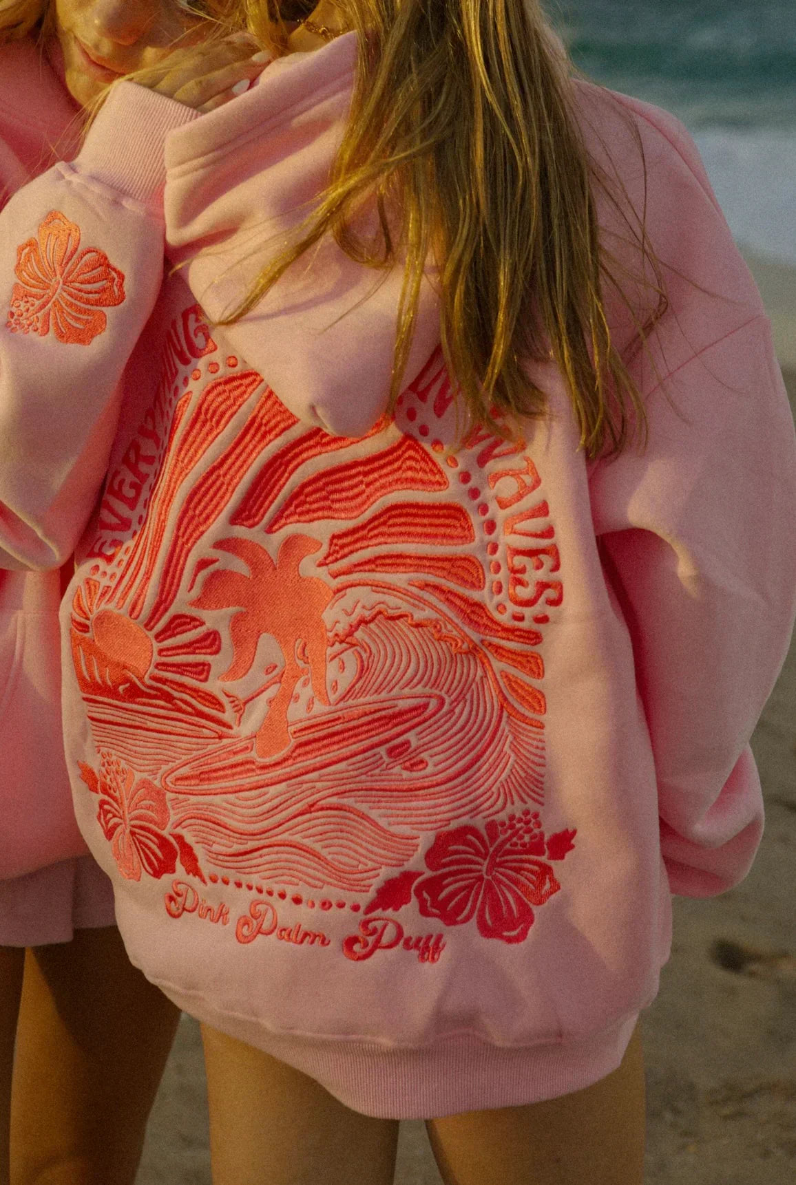 Back view of a woman wearing the Luna Women's Graphic Hoodie, showcasing a detailed graphic design with a relaxed fit, perfect for casual and cozy wear.