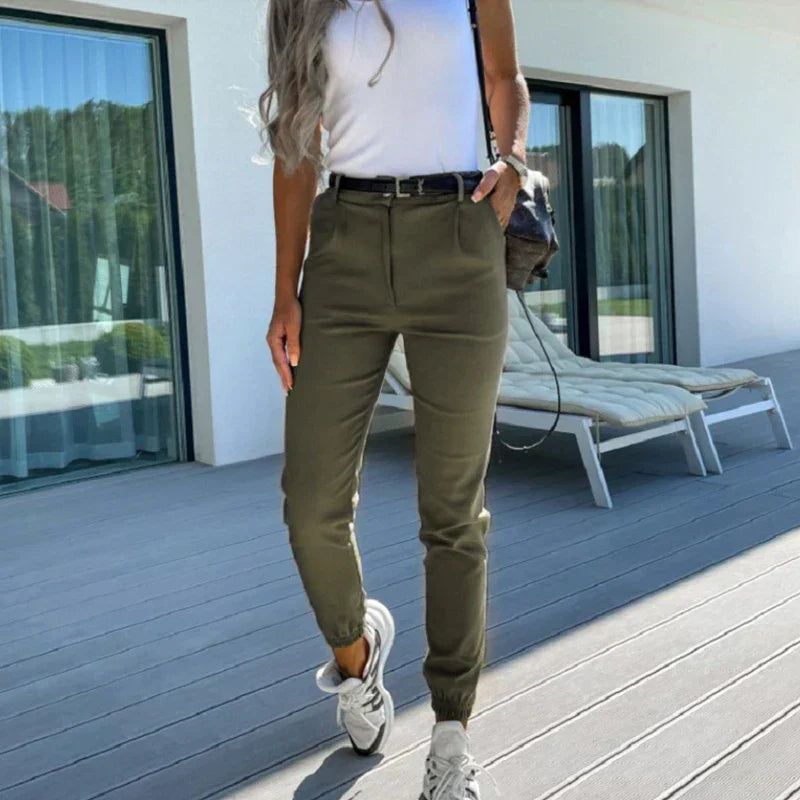 Back view of a woman wearing the Sophie Women's Casual Tapered Pants, styled with a chic, relaxed fit, paired with a casual blouse and sneakers, holding a stylish handbag, and showcasing an effortlessly elegant and comfortable look.