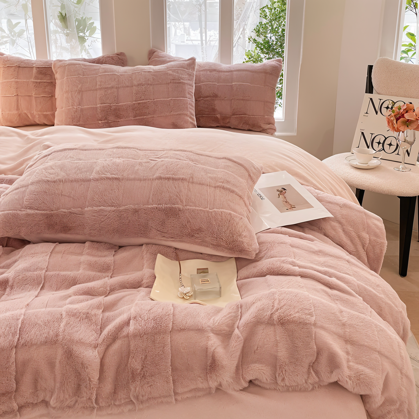 Luxurious bedding set showcasing ultra-soft textures, plush pillows, and a cozy blanket arranged on a neatly made bed in a stylish bedroom setting.