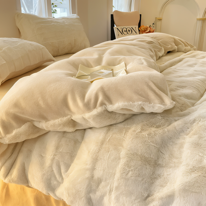 Luxurious bedding set showcasing ultra-soft textures, plush pillows, and a cozy blanket arranged on a neatly made bed in a stylish bedroom setting.