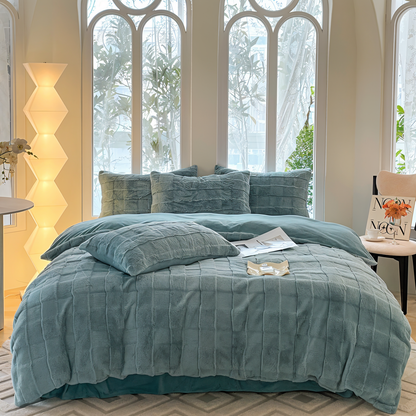 Luxurious bedding set showcasing ultra-soft textures, plush pillows, and a cozy blanket arranged on a neatly made bed in a stylish bedroom setting.