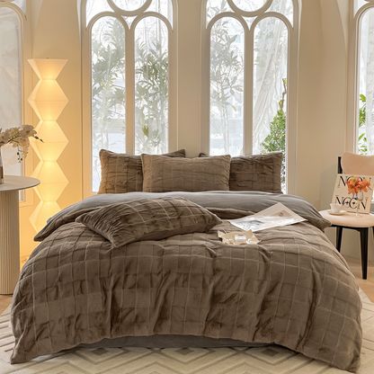 Luxurious bedding set showcasing ultra-soft textures, plush pillows, and a cozy blanket arranged on a neatly made bed in a stylish bedroom setting.