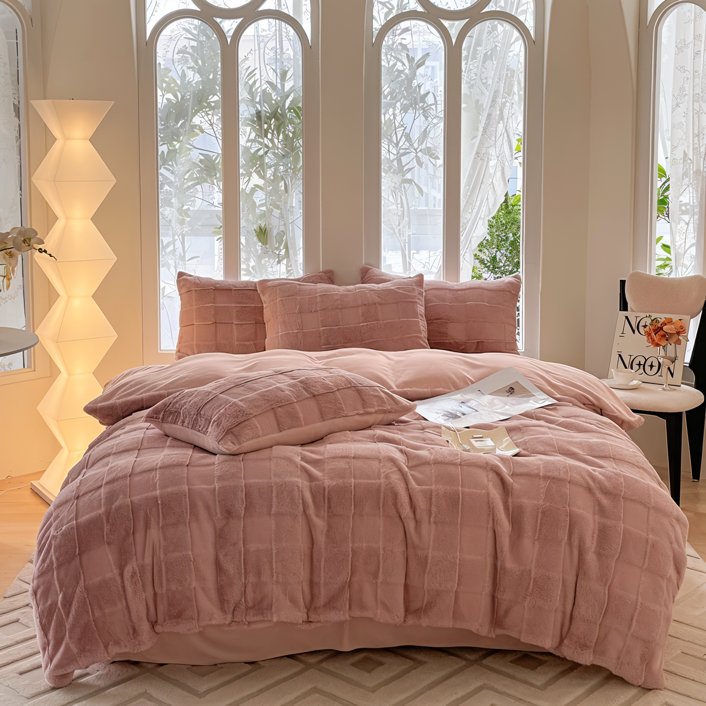 Luxurious bedding set showcasing ultra-soft textures, plush pillows, and a cozy blanket arranged on a neatly made bed in a stylish bedroom setting.