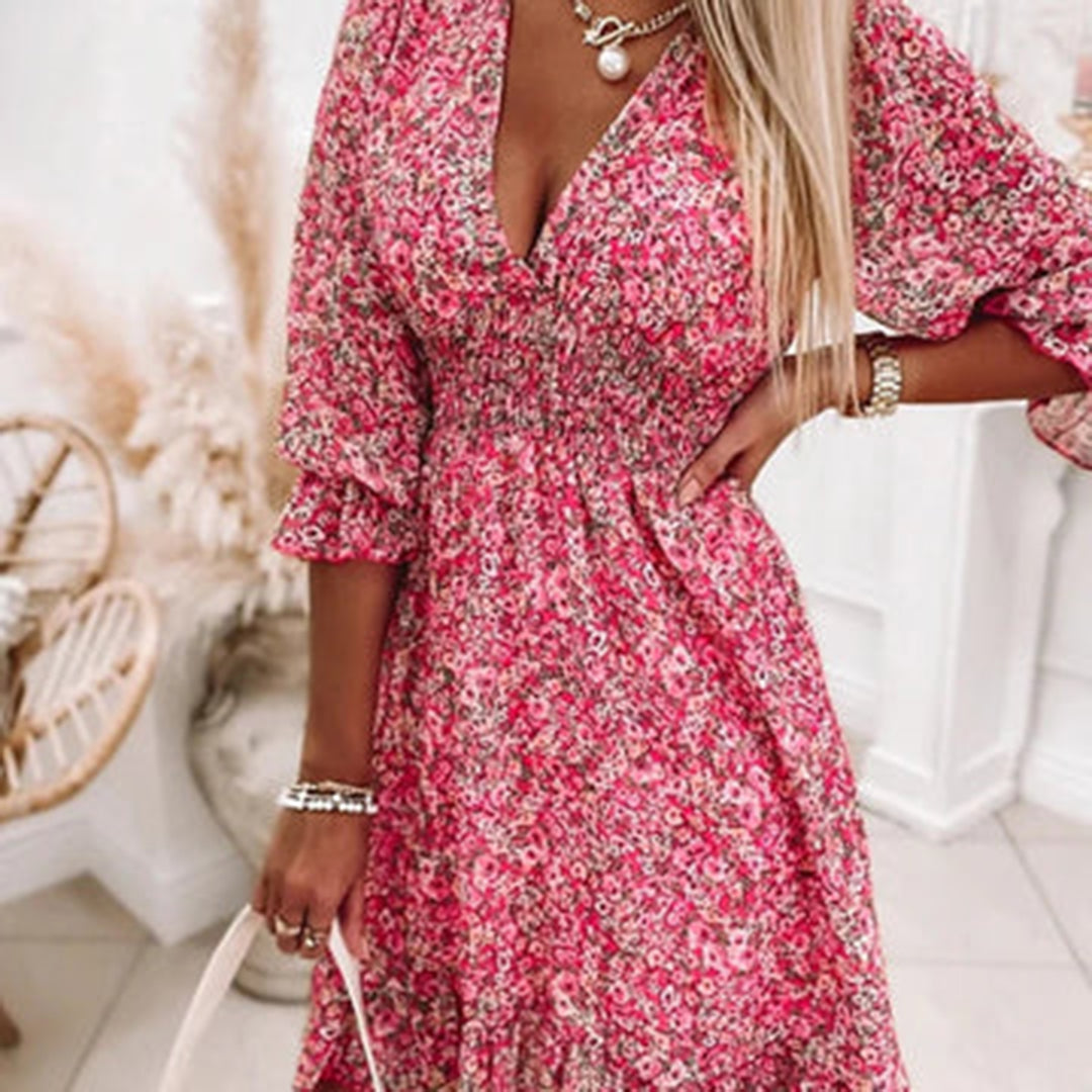 Woman wearing a floral dress with a flowy fit, featuring a V-neckline and ruffled hem, ideal for casual outings or special occasions.