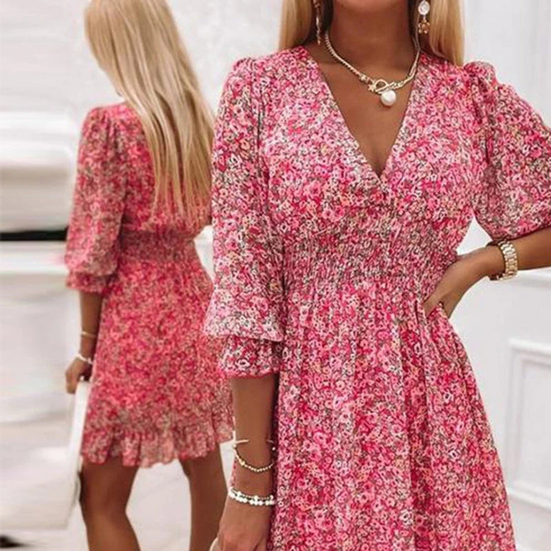 Woman wearing a floral dress with a flowy fit, featuring a V-neckline and ruffled hem, ideal for casual outings or special occasions.