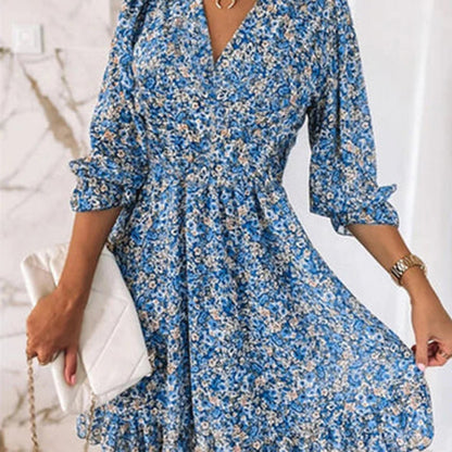 Woman wearing a floral dress with a flowy fit, featuring a V-neckline and ruffled hem, ideal for casual outings or special occasions.