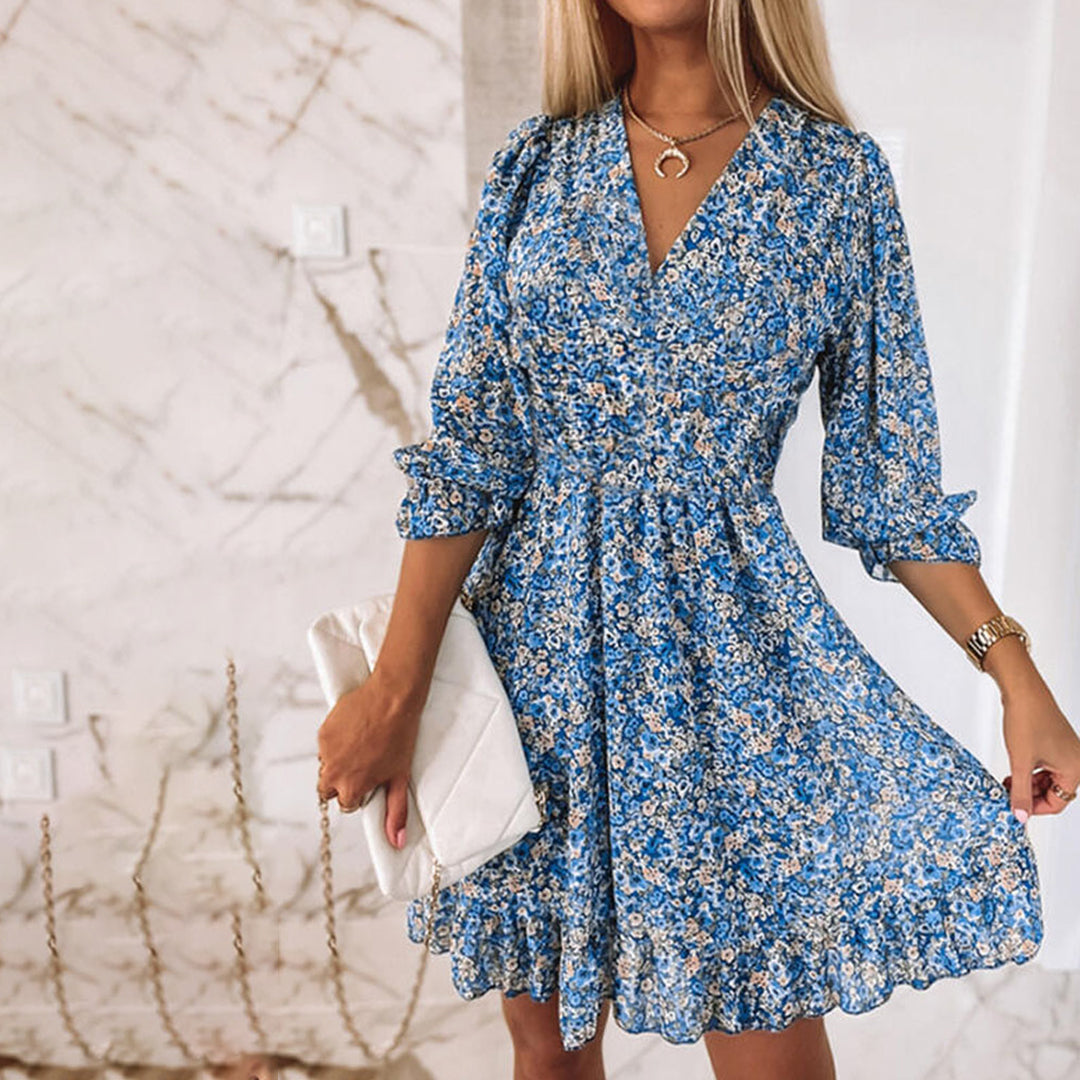 Woman wearing a floral dress with a flowy fit, featuring a V-neckline and ruffled hem, ideal for casual outings or special occasions.