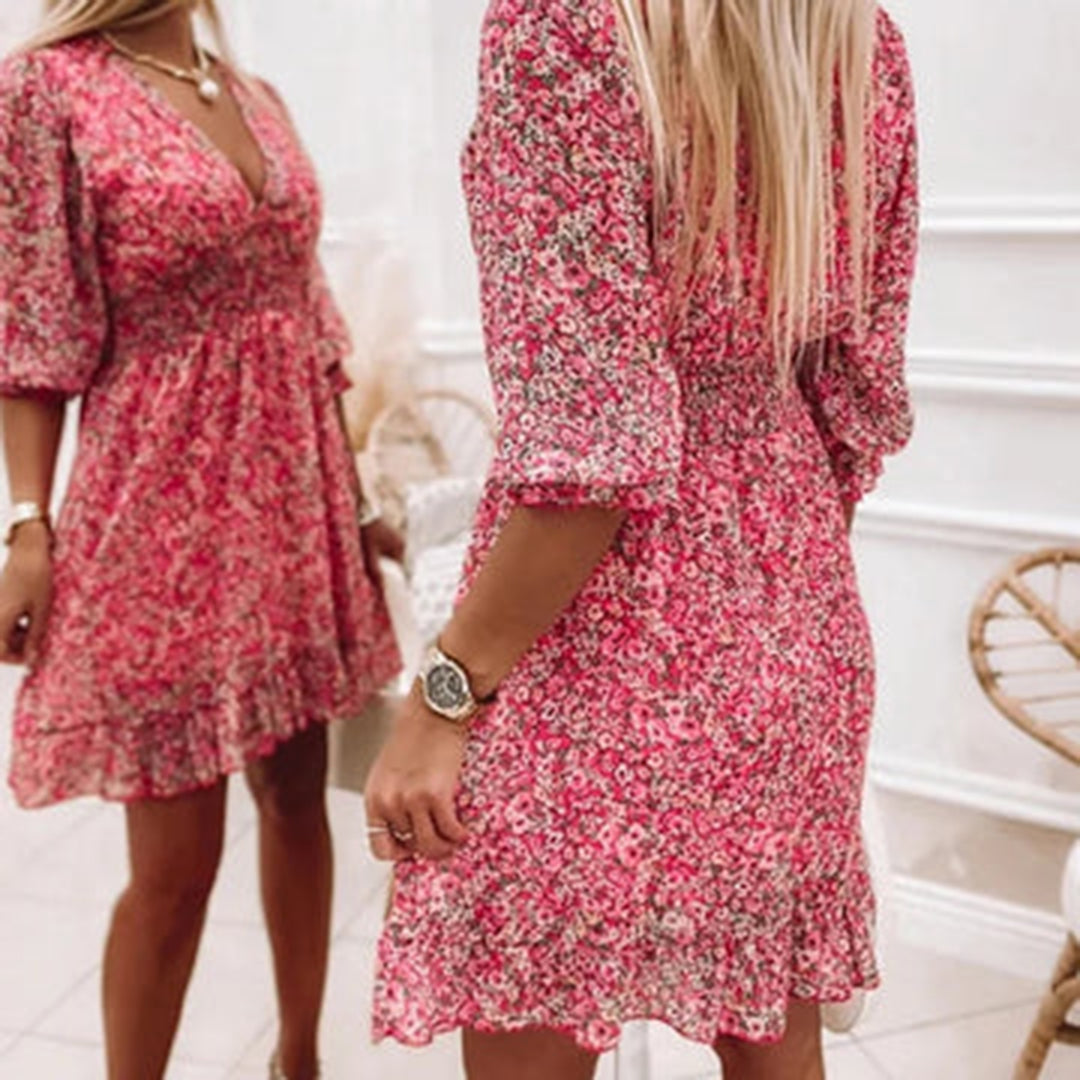 Woman wearing a floral dress with a flowy fit, featuring a V-neckline and ruffled hem, ideal for casual outings or special occasions.