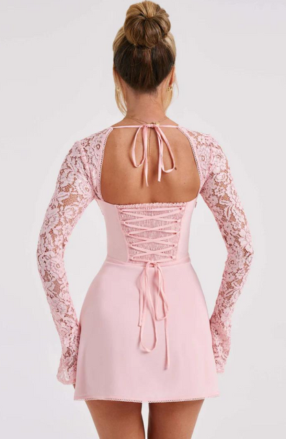 Model wearing the Lily Women's Lace Sleeve Dress, an elegant mini dress with intricate lace sleeves and a flattering fitted bodice, perfect for special occasions.