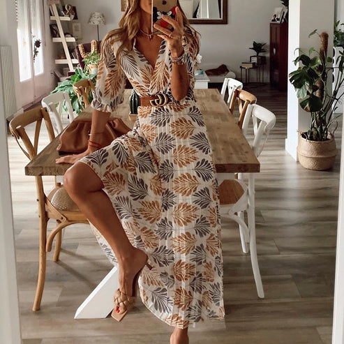 Model wearing the Elena Women's Leaf Print Dress, a flowing belted dress with nature-inspired leaf patterns, perfect for casual and semi-formal occasions.