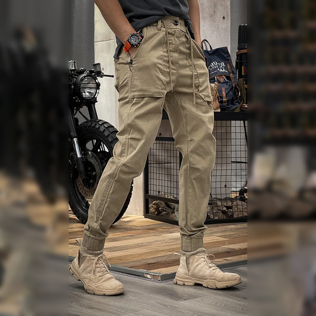 Men's cargo pants with a rugged design, featuring multiple functional pockets, a tapered fit, and an adjustable waistband for a stylish and versatile look.