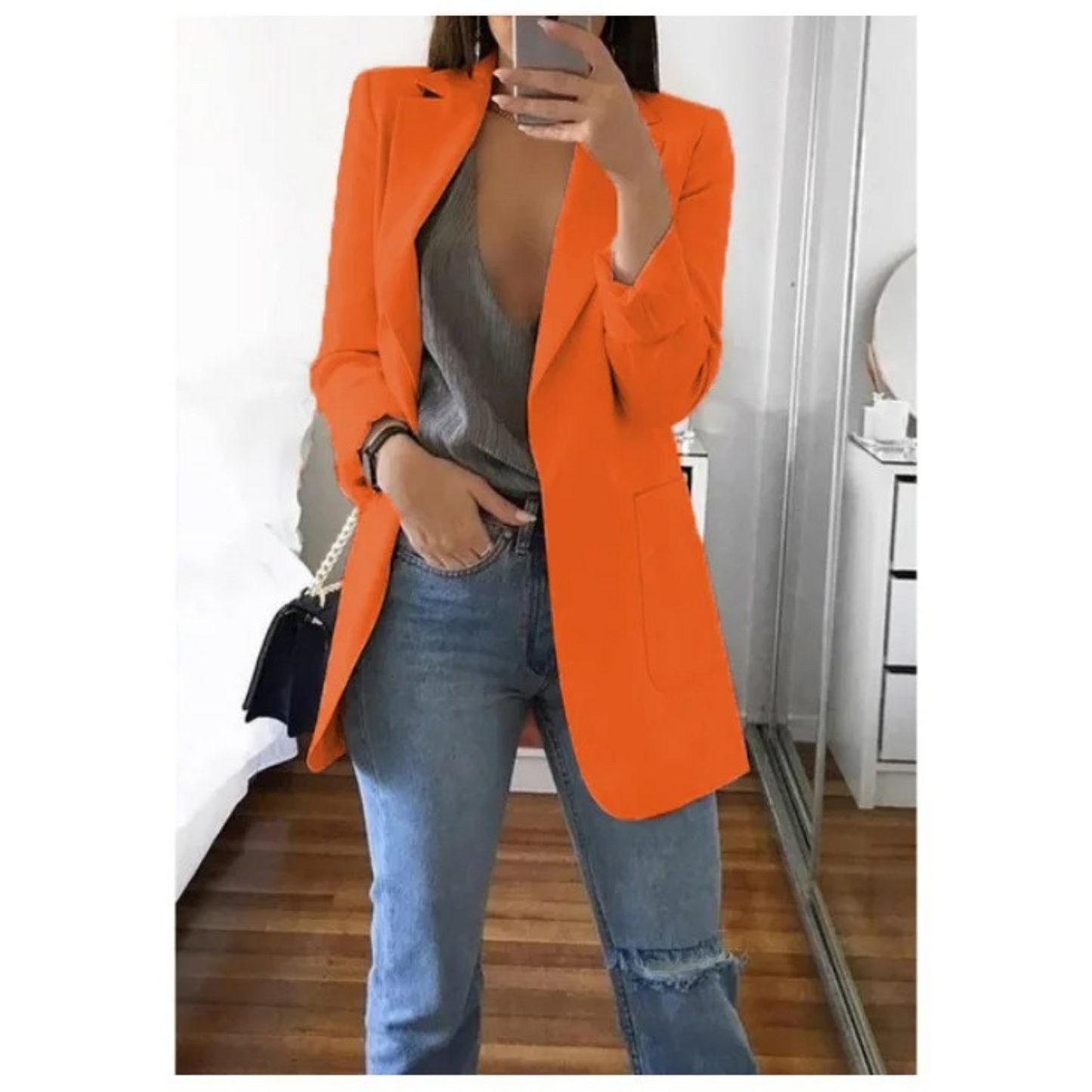 Woman wearing the elegant Sophie | Stylish Long Blazer for Women, with a structured, streamlined cut. The blazer is paired with a top and jeans, creating a smart-casual look perfect for the office or a night out.