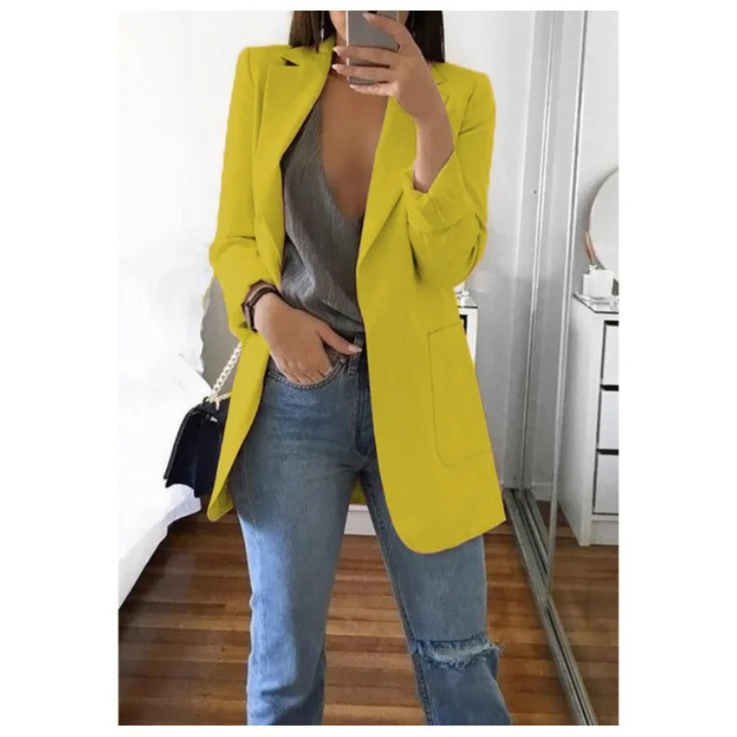 Woman wearing the elegant Sophie | Stylish Long Blazer for Women, with a structured, streamlined cut. The blazer is paired with a top and jeans, creating a smart-casual look perfect for the office or a night out.