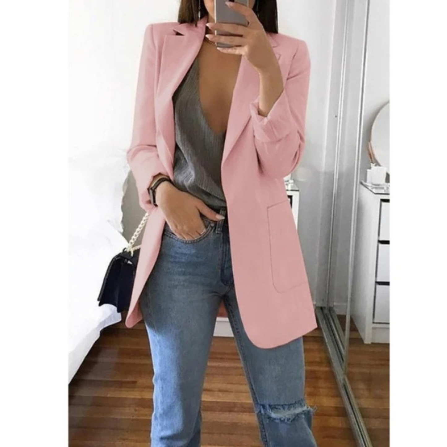 Woman wearing the elegant Sophie | Stylish Long Blazer for Women, with a structured, streamlined cut. The blazer is paired with a top and jeans, creating a smart-casual look perfect for the office or a night out.