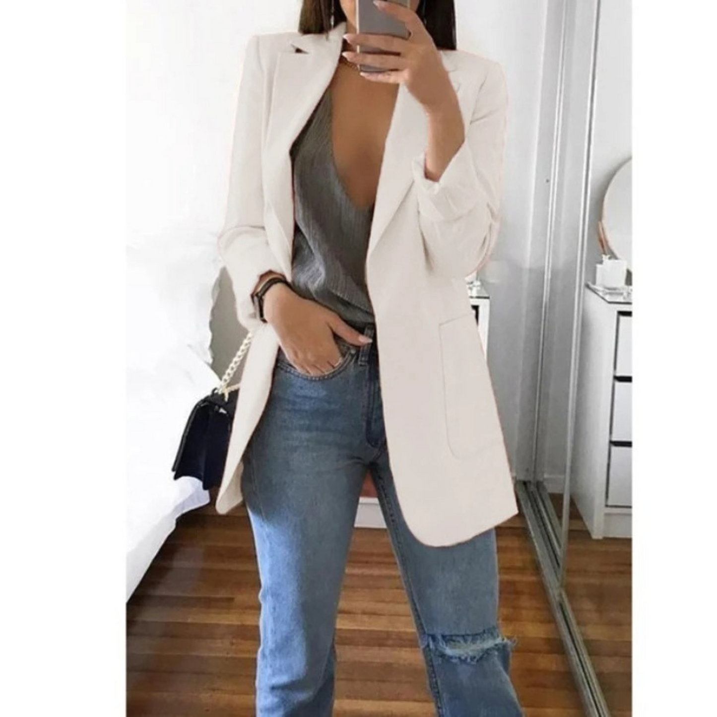 Woman wearing the elegant Sophie | Stylish Long Blazer for Women, with a structured, streamlined cut. The blazer is paired with a top and jeans, creating a smart-casual look perfect for the office or a night out.