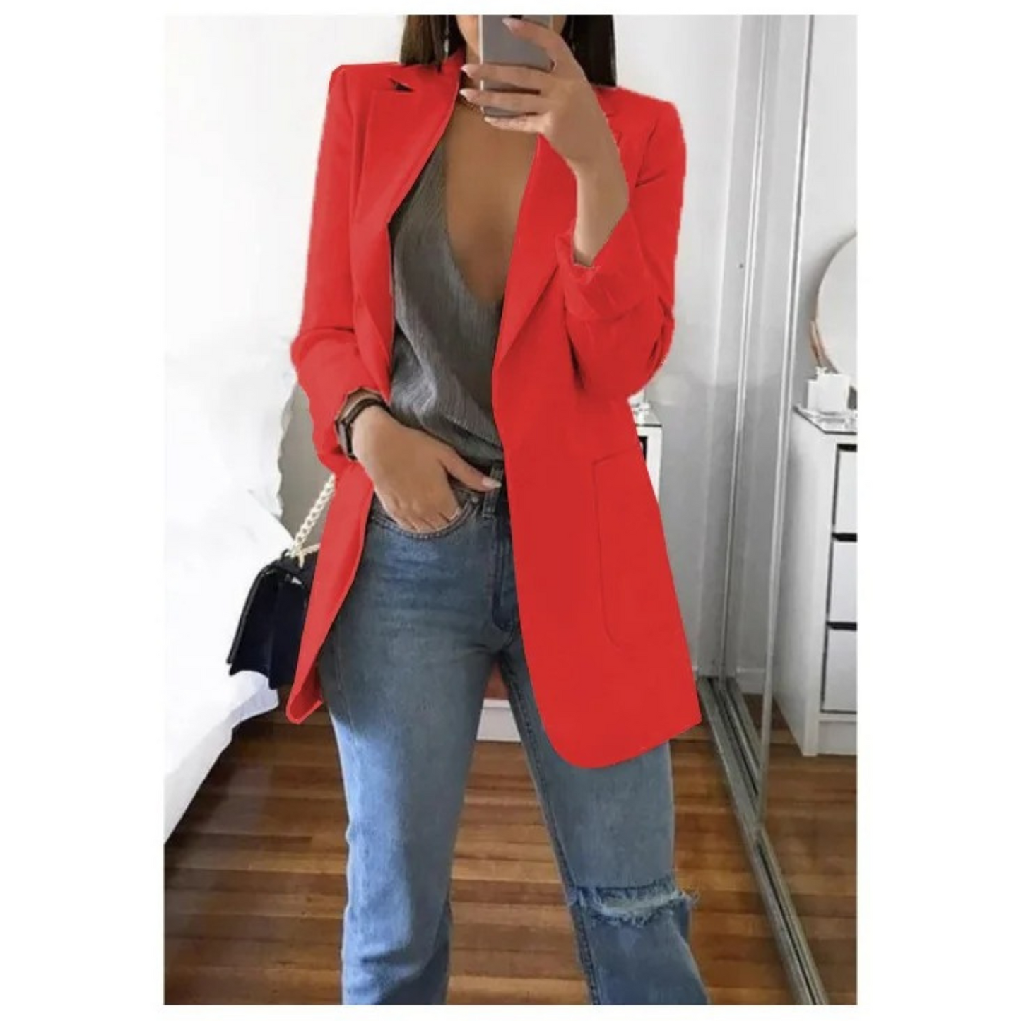 Woman wearing the elegant Sophie | Stylish Long Blazer for Women, with a structured, streamlined cut. The blazer is paired with a top and jeans, creating a smart-casual look perfect for the office or a night out.