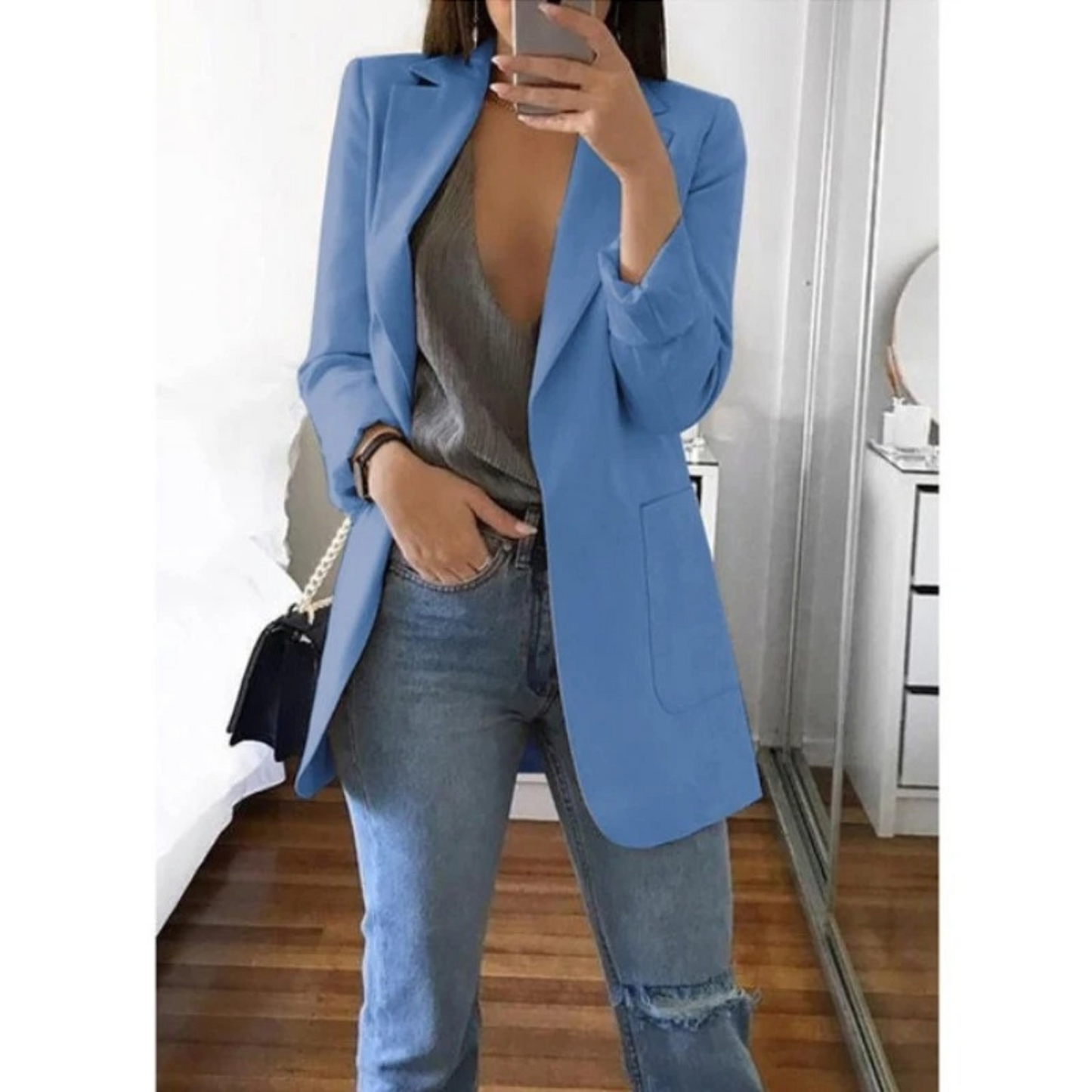 Woman wearing the elegant Sophie | Stylish Long Blazer for Women, with a structured, streamlined cut. The blazer is paired with a top and jeans, creating a smart-casual look perfect for the office or a night out.