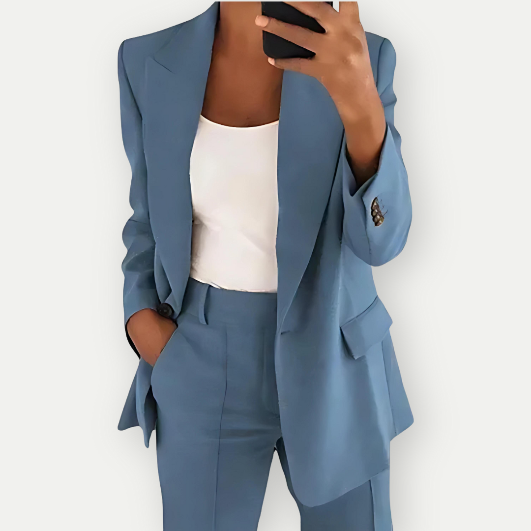 Woman wearing the Samantha Women's Tailored Blazer Set, featuring a fitted blazer with notch lapels and matching tailored pants, paired with a simple top, showcasing a chic and polished look perfect for both professional and casual occasions.