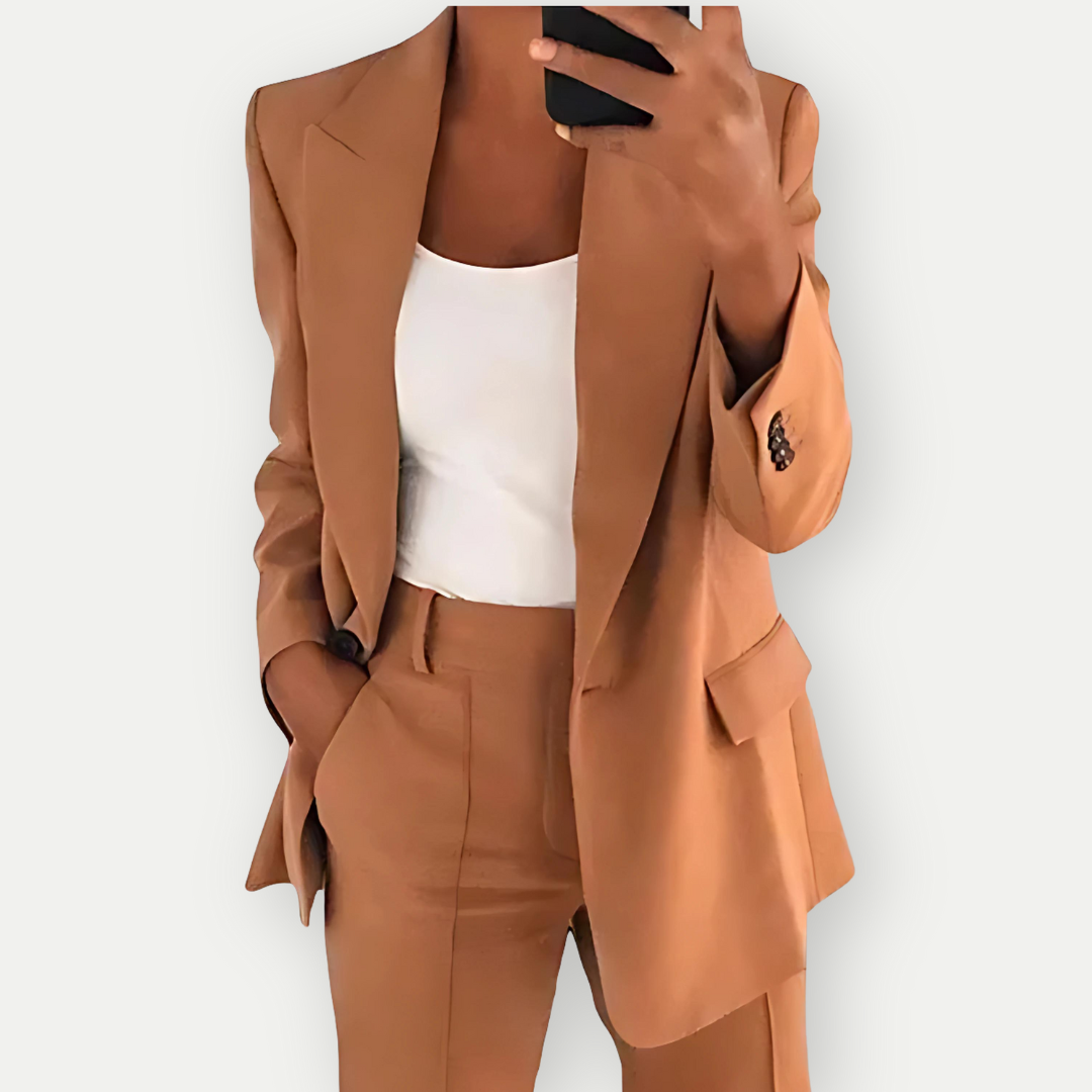 Woman wearing the Samantha Women's Tailored Blazer Set, featuring a fitted blazer with notch lapels and matching tailored pants, paired with a simple top, showcasing a chic and polished look perfect for both professional and casual occasions.