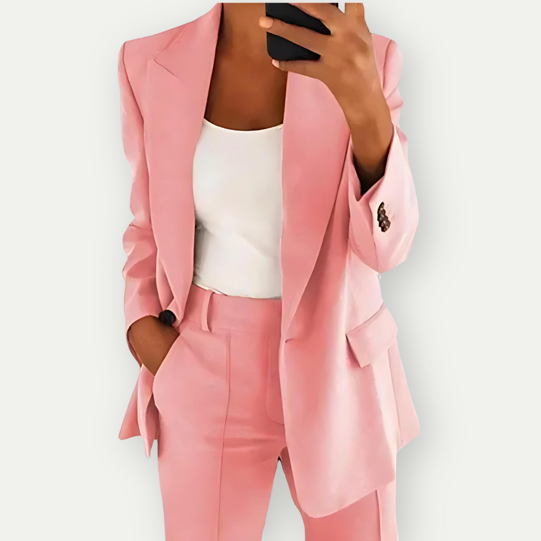 Woman wearing the Samantha Women's Tailored Blazer Set, featuring a fitted blazer with notch lapels and matching tailored pants, paired with a simple top, showcasing a chic and polished look perfect for both professional and casual occasions.