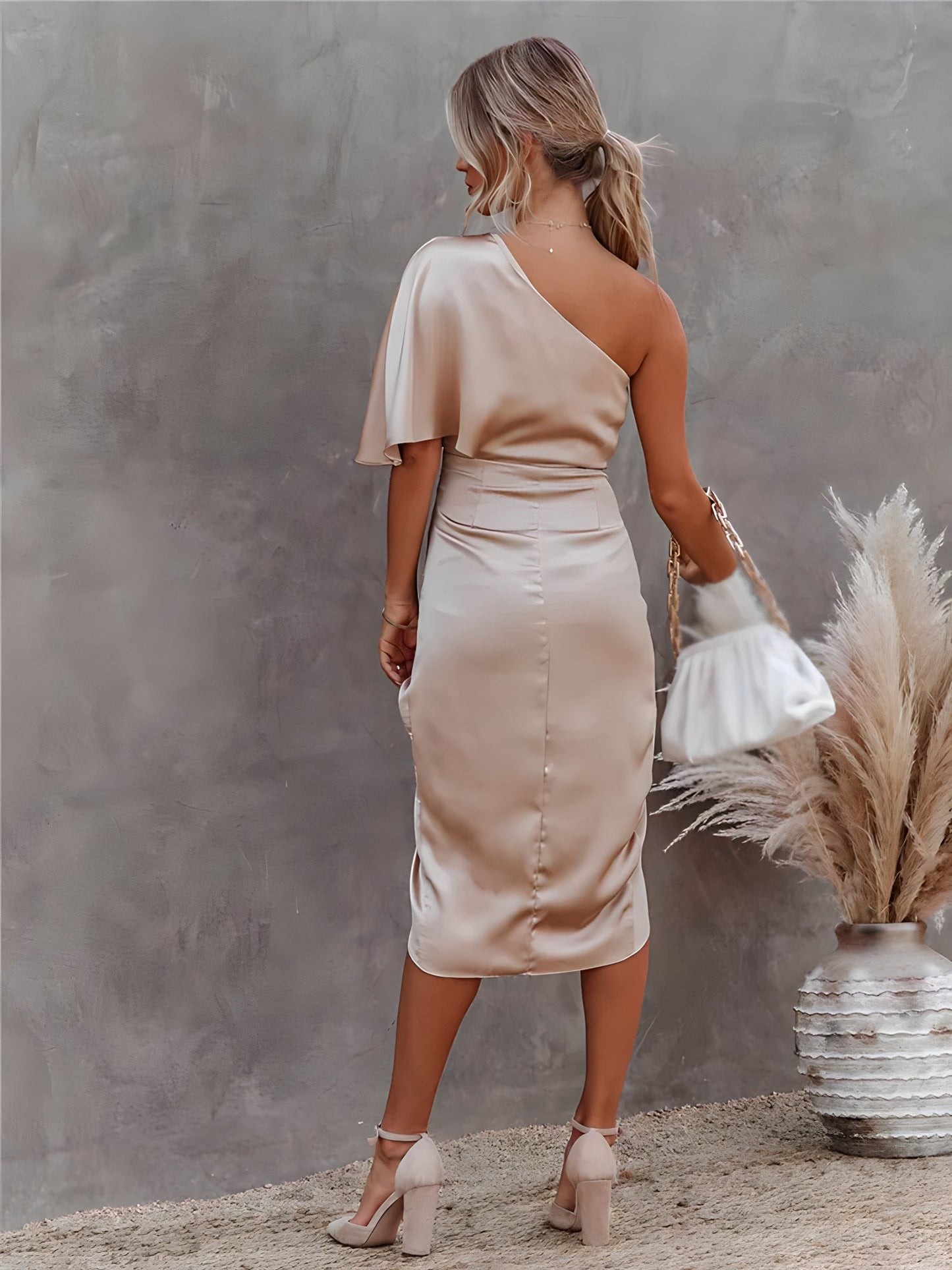 Model wearing the Elena Women's One-Shoulder Satin Dress, showcasing an elegant design with a luxurious satin texture, ruched detailing, and a stylish one-shoulder sleeve, perfect for formal events or special occasions.