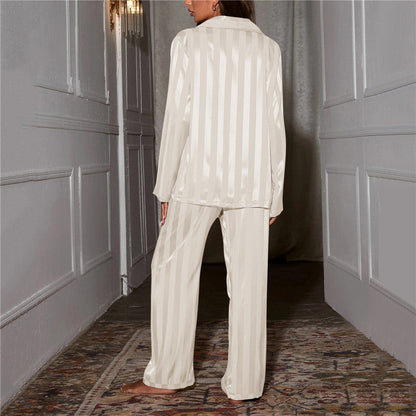A woman wearing a luxurious satin pajama set featuring a button-up shirt and relaxed-fit pants, perfect for comfortable and elegant loungewear or sleepwear. Ideal for cozy nights or stylish relaxation at home.