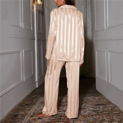 A woman wearing a luxurious satin pajama set featuring a button-up shirt and relaxed-fit pants, perfect for comfortable and elegant loungewear or sleepwear. Ideal for cozy nights or stylish relaxation at home.