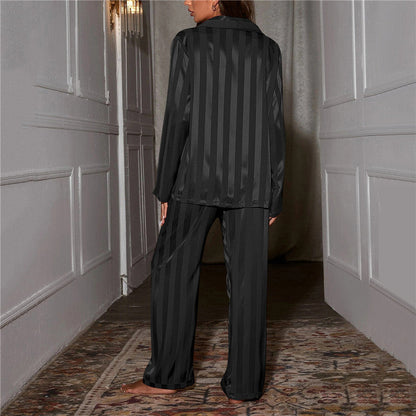 A woman wearing a luxurious satin pajama set featuring a button-up shirt and relaxed-fit pants, perfect for comfortable and elegant loungewear or sleepwear. Ideal for cozy nights or stylish relaxation at home.