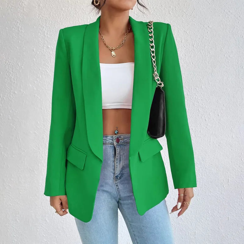 A woman wearing a stylish tailored blazer over a crop top and high-waisted jeans, creating a chic and modern look. The blazer features a structured fit with pockets, adding sophistication to the casual outfit. Perfect for elevating any ensemble with a touch of elegance.