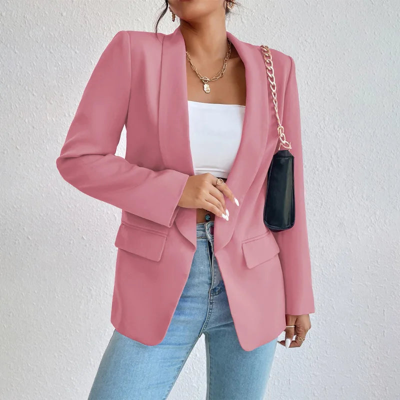 A woman wearing a stylish tailored blazer over a crop top and high-waisted jeans, creating a chic and modern look. The blazer features a structured fit with pockets, adding sophistication to the casual outfit. Perfect for elevating any ensemble with a touch of elegance.