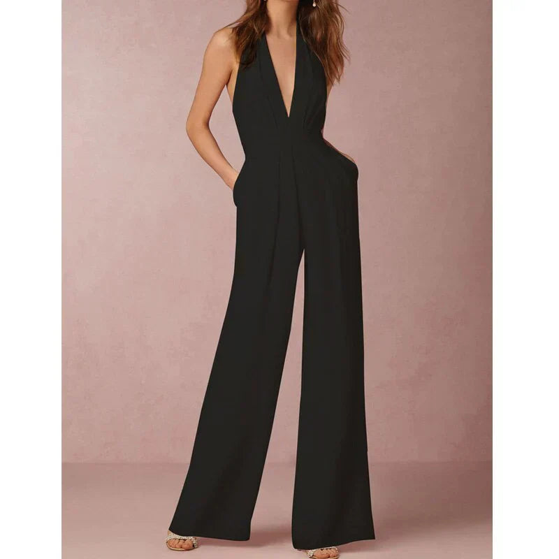 Model wearing the Bella | Plunging Halter Jumpsuit featuring a deep neckline, fitted waist, and flowing wide-leg silhouette, perfect for making a bold fashion statement at formal events or special occasions.