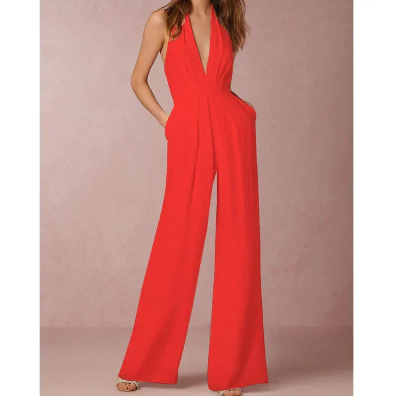 Model wearing the Bella | Plunging Halter Jumpsuit featuring a deep neckline, fitted waist, and flowing wide-leg silhouette, perfect for making a bold fashion statement at formal events or special occasions.