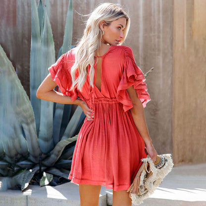 Women's flowy dress with elegant ruffle sleeves, a deep V-neckline, button-down front, and a cinched waist, perfect for a stylish and lightweight look.