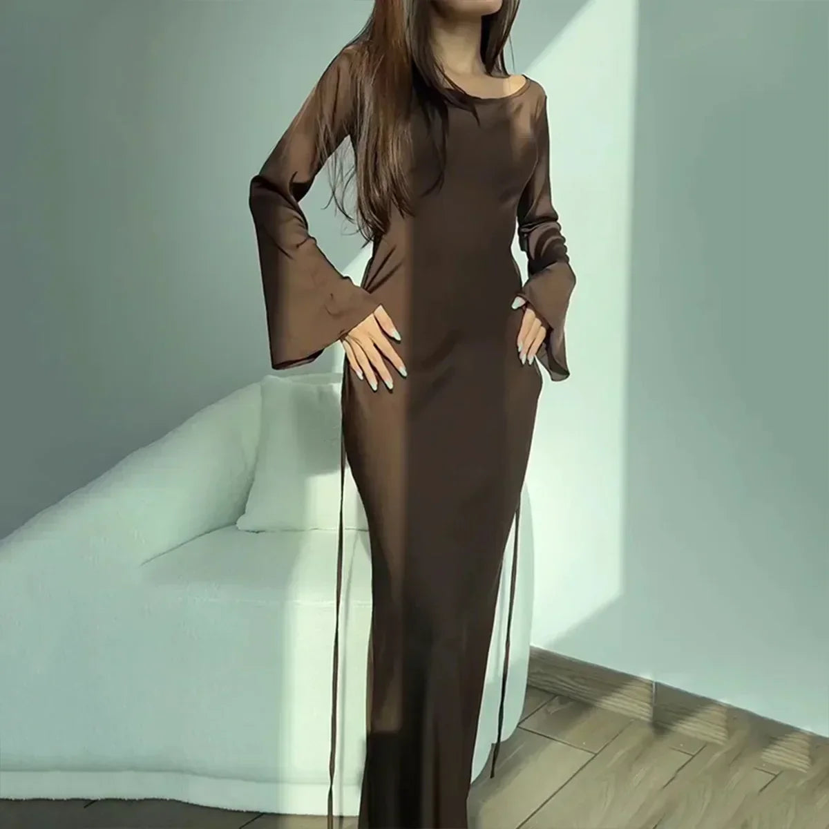 A woman gracefully modeling the Sophia | Women's Elegant Maxi Dress | Flowy Evening Gown, showcasing its sophisticated and flowing design, perfect for formal events or special occasions. The dress features long sleeves and a fitted silhouette that exudes elegance and charm.