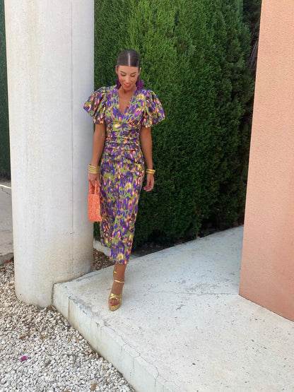 Model wearing the Amelia | Women's Statement Puff-Sleeve Dress | Vibrant Print Dress, featuring dramatic puff sleeves and a form-flattering design, paired with bold accessories for an elegant and stylish look.