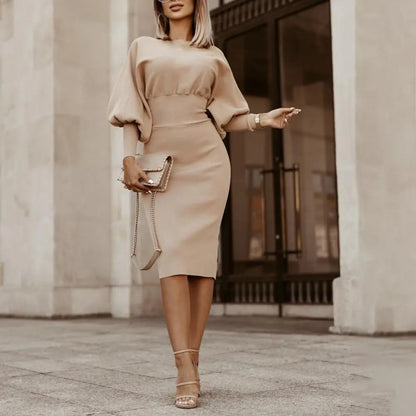 A stylish woman wearing the Sophia | Women's Elegant Midi Dress | Puff Sleeve Dress, showcasing its fitted silhouette, puff sleeves, and refined midi length, ideal for formal or semi-formal occasions.