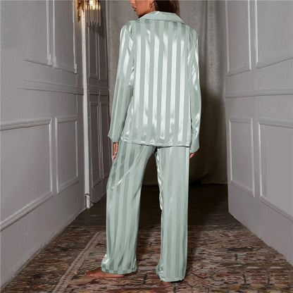 A woman wearing a luxurious satin pajama set featuring a button-up shirt and relaxed-fit pants, perfect for comfortable and elegant loungewear or sleepwear. Ideal for cozy nights or stylish relaxation at home.