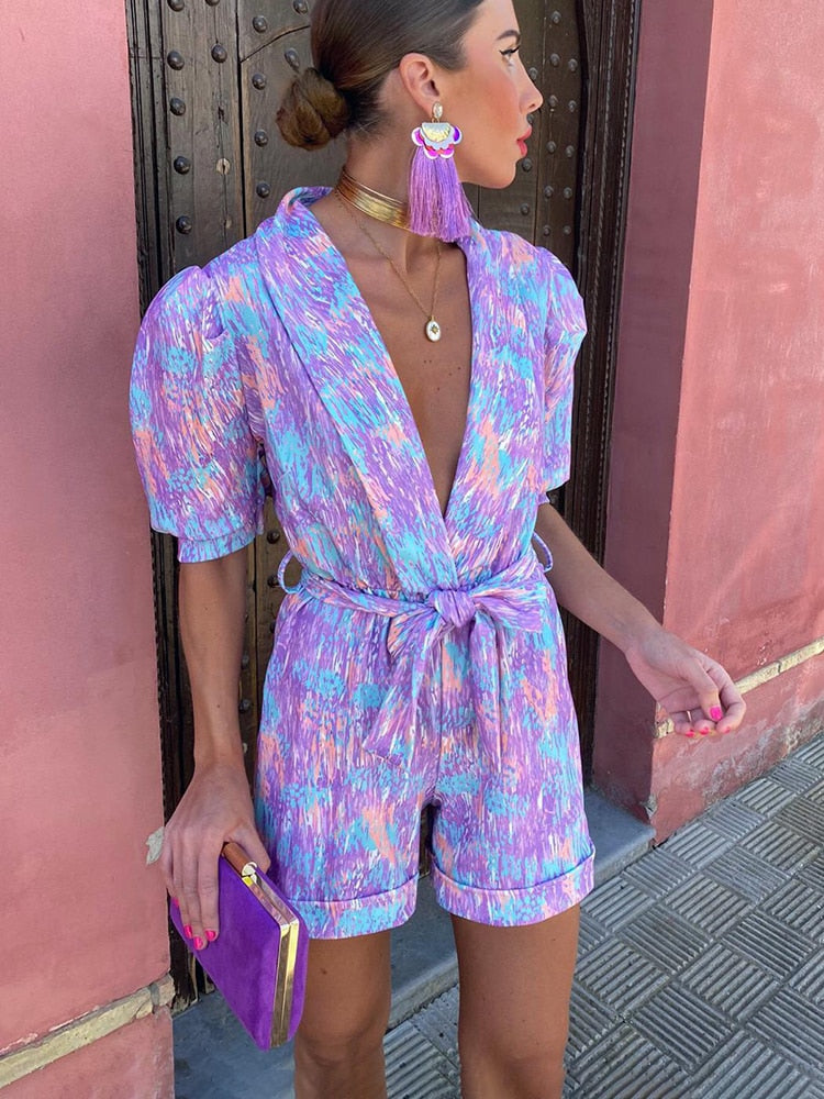 Model wearing the Isla Vibrant Tie-Waist Short Sleeve Romper, featuring a flattering tie-waist and short sleeves, perfect for casual outings or chic summer looks.