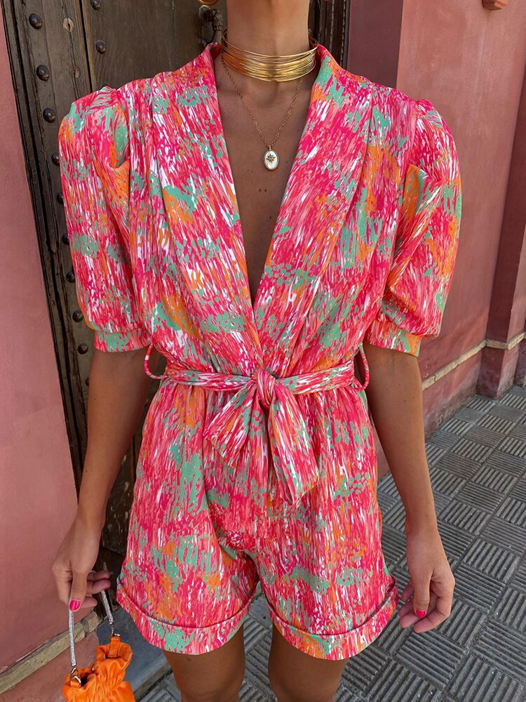 Model wearing the Isla Vibrant Tie-Waist Short Sleeve Romper, featuring a flattering tie-waist and short sleeves, perfect for casual outings or chic summer looks.