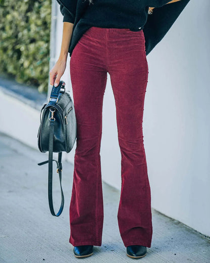 Model wearing the Isabelle | High-Waisted Flare Pants, featuring a flattering high-waist and chic flare cut. These pants offer a sleek, leg-lengthening silhouette, perfect for casual or dressy outfits, paired with a cozy knit sweater and neutral accessories.