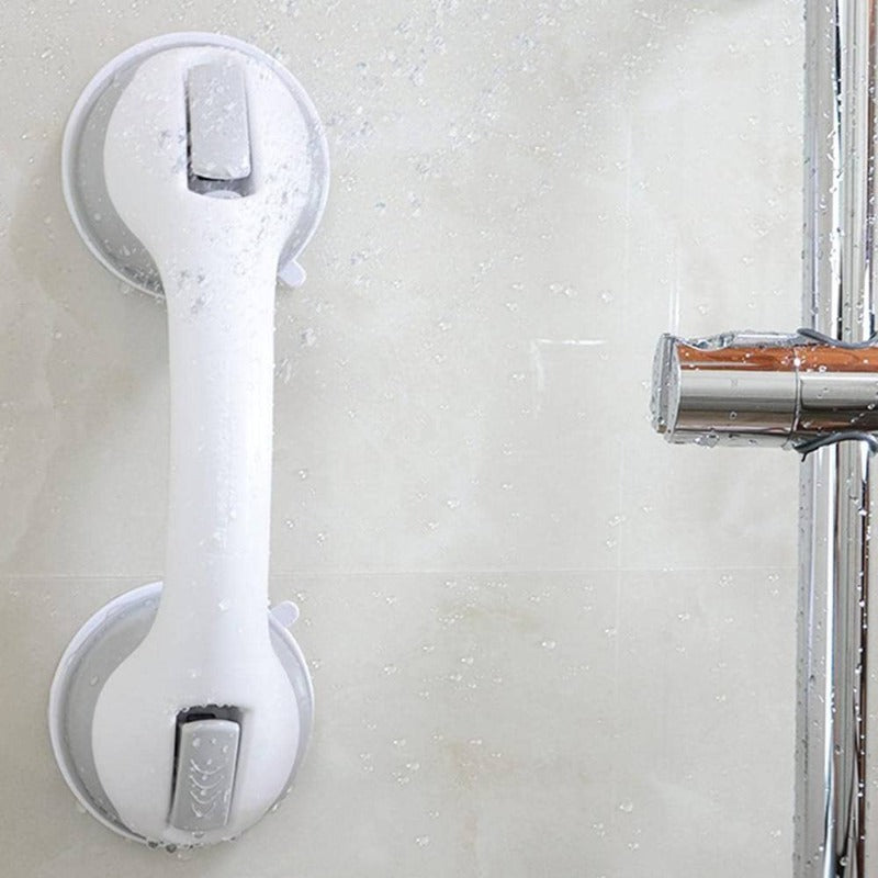  Person securing a bathroom support handle with suction cups, designed for stability and grip on smooth surfaces.