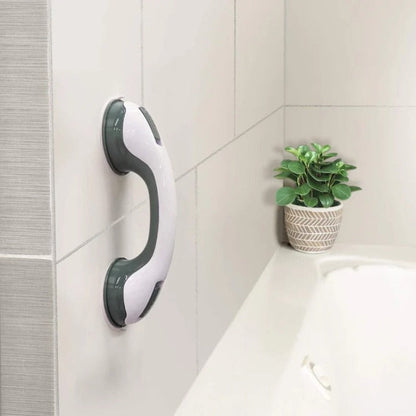  Person securing a bathroom support handle with suction cups, designed for stability and grip on smooth surfaces.