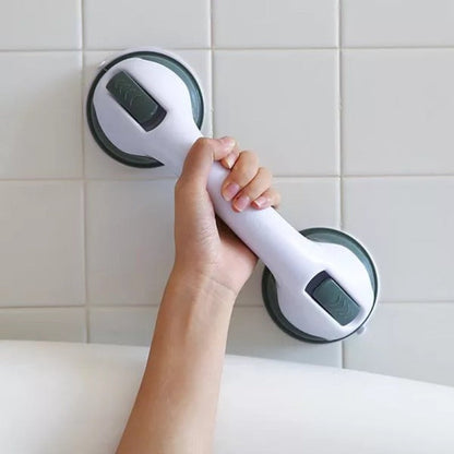  Person securing a bathroom support handle with suction cups, designed for stability and grip on smooth surfaces.