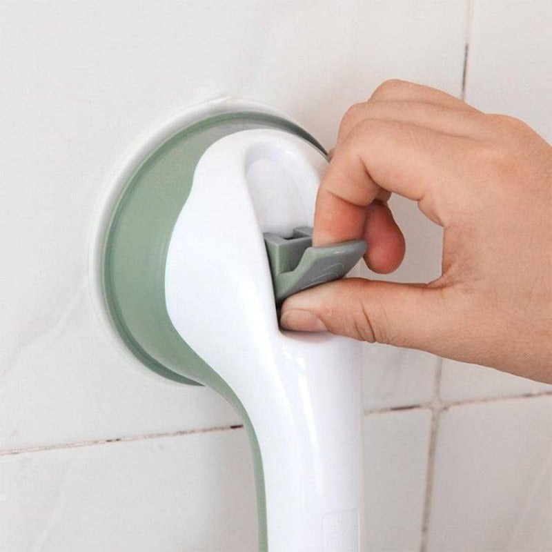  Person securing a bathroom support handle with suction cups, designed for stability and grip on smooth surfaces.