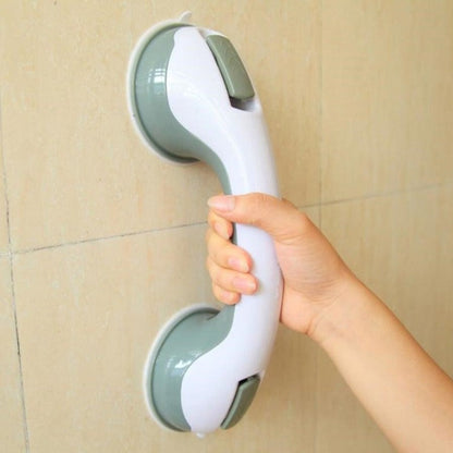  Person securing a bathroom support handle with suction cups, designed for stability and grip on smooth surfaces.