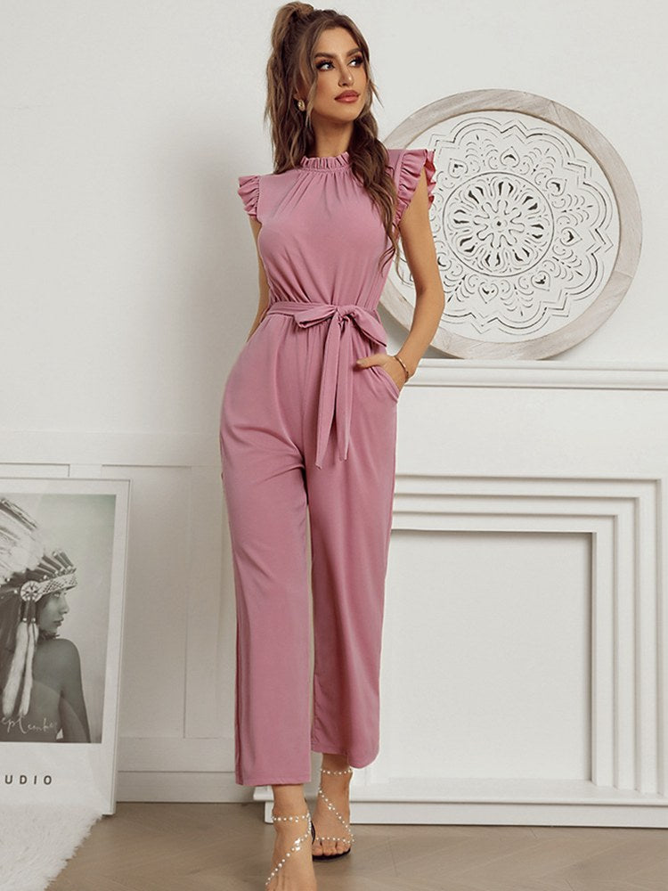 A model wearing the Sophia Women's Ruffled Jumpsuit featuring stylish ruffled sleeves, a high neckline, and a flattering tie-waist design, paired with wide-leg pants, showcasing an elegant and versatile outfit suitable for various occasions.